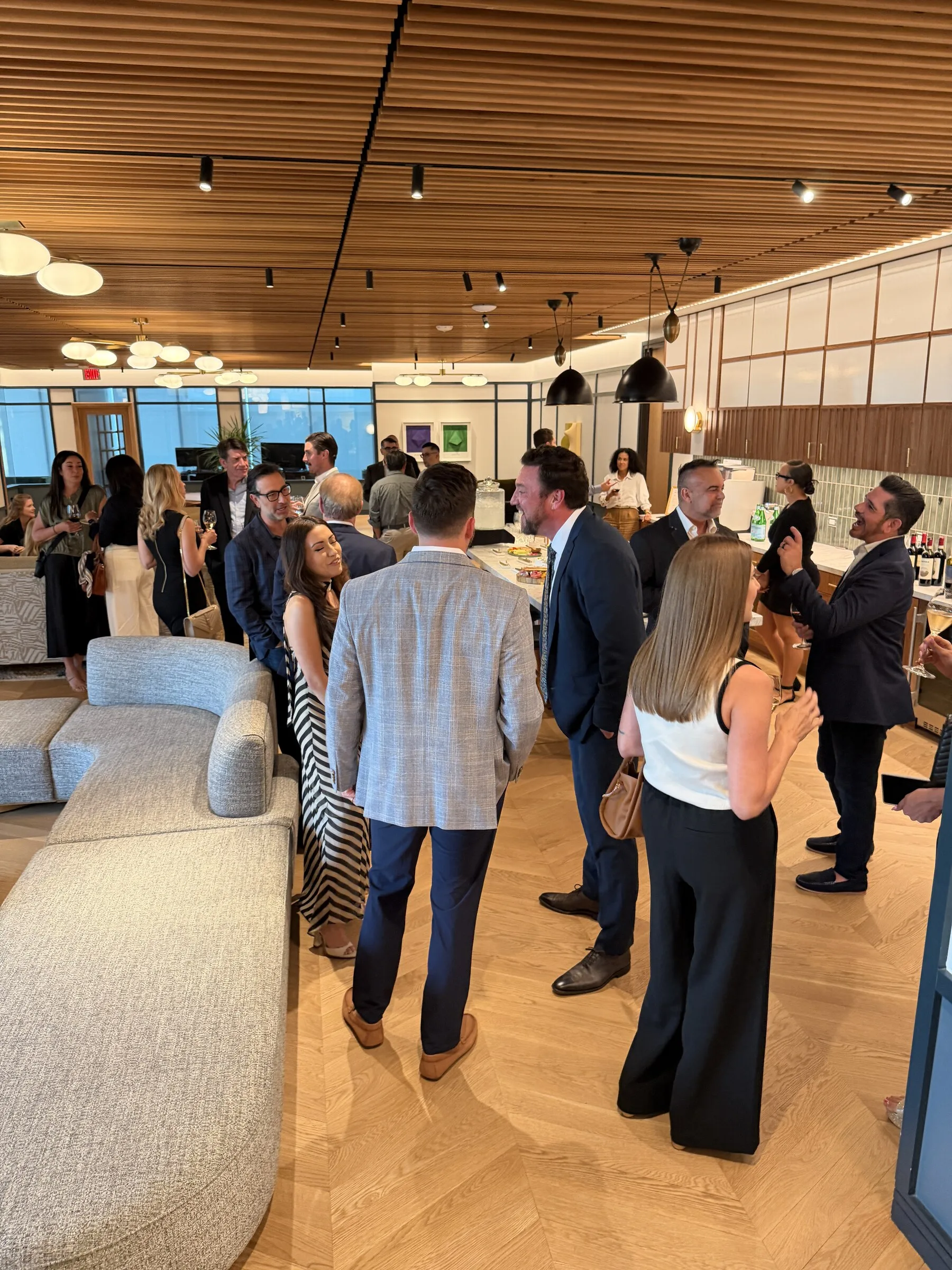 An evening at The Room - a warmly lit private space with guests mid-conversation.